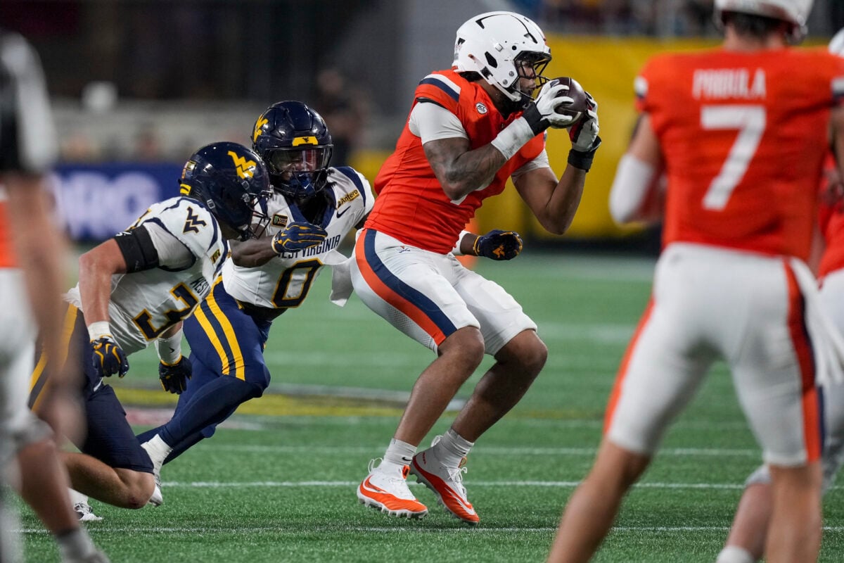 Sep 19, 2026; Charlotte, North Carolina, USA;  Virginia Cavaliers tight end Dakota Twitty (9) catches a pass from quarterback Beau Pribula (7) and pursued by West Virginia Mountaineers safety Andrew Powdrell (0)during the second half against the West Virginia Mountaineers at Bank of America Stadium.  Mandatory Credit: Jim Dedmon-Imagn Images