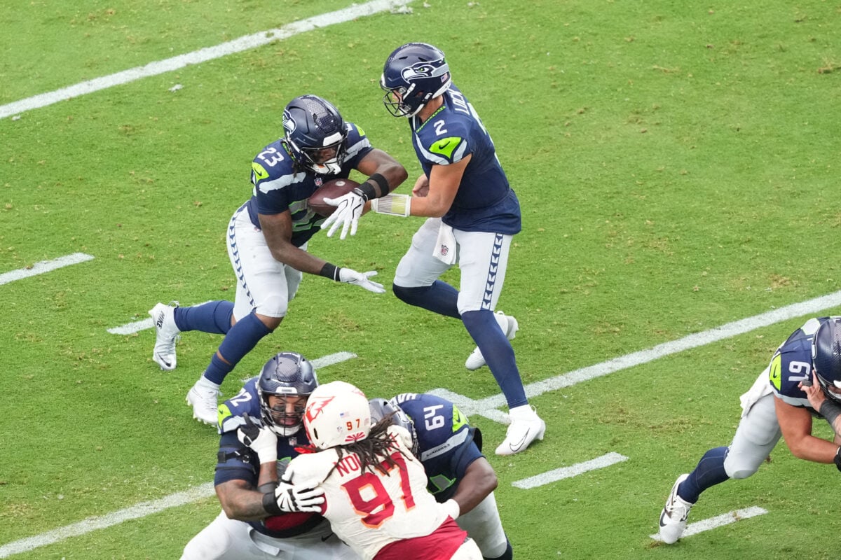 Sep 20, 2026; Glendale, Arizona, USA;  Seattle Seahawks quarterback Drew Lock (2) hands off the ball to running back Emanuel Wilson (23) in the third quarter against the Arizona Cardinals at State Farm Stadium.  Mandatory Credit: Joe Camporeale-Imagn Images