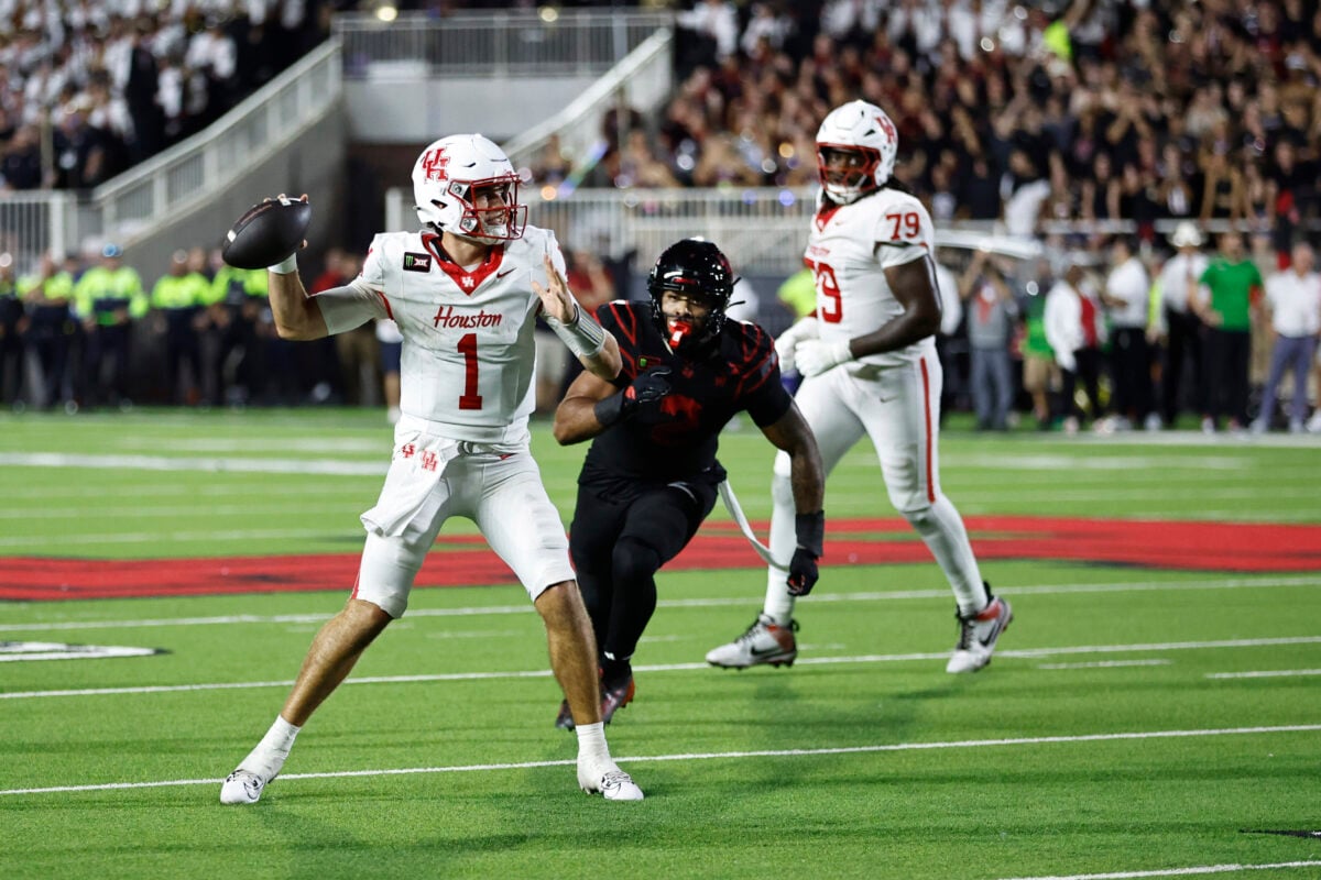 Sep 18, 2026; Lubbock, Texas, USA; Houston Cougars quarterback Conner Weigman (1) is pressured by Texas Tech Red Raiders defensive end Trey White (2) in the second half at Galaxy Stadium. Mandatory Credit: Michael C. Johnson-Imagn Images