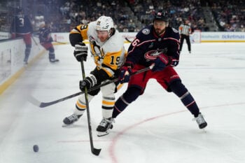 Sep 24, 2026; Columbus, Ohio, USA;  Pittsburgh Penguins center Connor Dewar (19) skates for the puck against Columbus Blue Jackets forward Kirill Marchenko (86) in the second period at Nationwide Arena. Mandatory Credit: Aaron Doster-Imagn Images