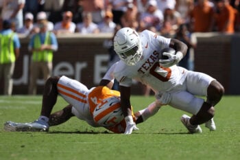 Sep 26, 2026; Knoxville, Tennessee, USA;  Tennessee Volunteers defensive back Ty Redmond (4) tackles Texas Longhorns running back Raleek Brown (0) during the second half at Neyland Stadium.  Mandatory Credit: Randy Sartin-Imagn Images