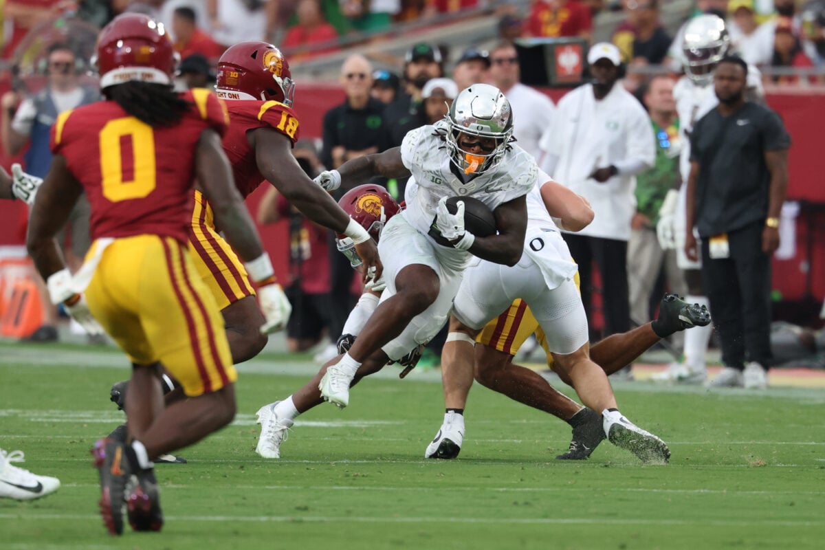 Sep 26, 2026; Los Angeles, California, USA;  Oregon Ducks running back Jordon Davison (0) runs against the USC Trojans defense during the first half at United Airlines Field at Los Angeles Memorial Coliseum.  Mandatory Credit: Kiyoshi Mio-Imagn Images