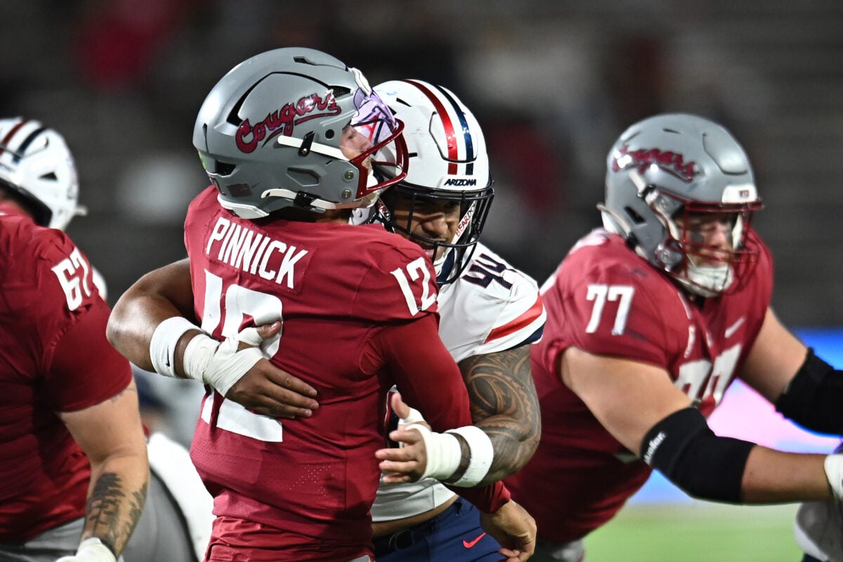 Sep 26, 2026; Pullman, Washington, USA;  Washington State Cougars quarterback Caden Pinnick (12) is hot as he throws by Arizona Wildcats defensive lineman Prince Williams (44) during the second half at Gesa Field at Martin Stadium.  Mandatory Credit: James Snook-Imagn Images