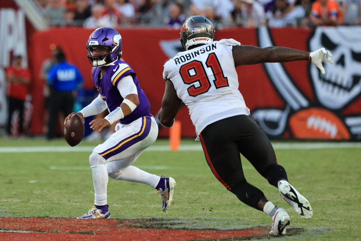Sep 27, 2026; Tampa, Florida, USA; Minnesota Vikings quarterback Kyler Murray (1) scrambles with the ball under pressure from Tampa Bay Buccaneers defensive tackle A'Shawn Robinson (91) during the fourth quarter at Raymond James Stadium. Mandatory Credit: Kim Klement Neitzel-Imagn Images