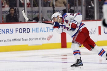 Oct 2, 2026; Detroit, Michigan, USA;  New York Rangers defenseman Adam Fox (23) takes a shot in the third period against the Detroit Red Wings at Little Caesars Arena.  Mandatory Credit: Rick Osentoski-Imagn Images