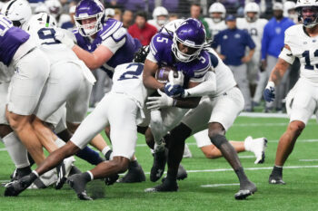 Oct 2, 2026; Evanston, Illinois, USA;  Northwestern Wildcats running back Caleb Komolafe (5) runs the to the one yard line as Penn State Nittany Lions cornerback Audavion Collins (2) tackles him during the second half at New Ryan Field.  Mandatory Credit: David Banks-Imagn Images