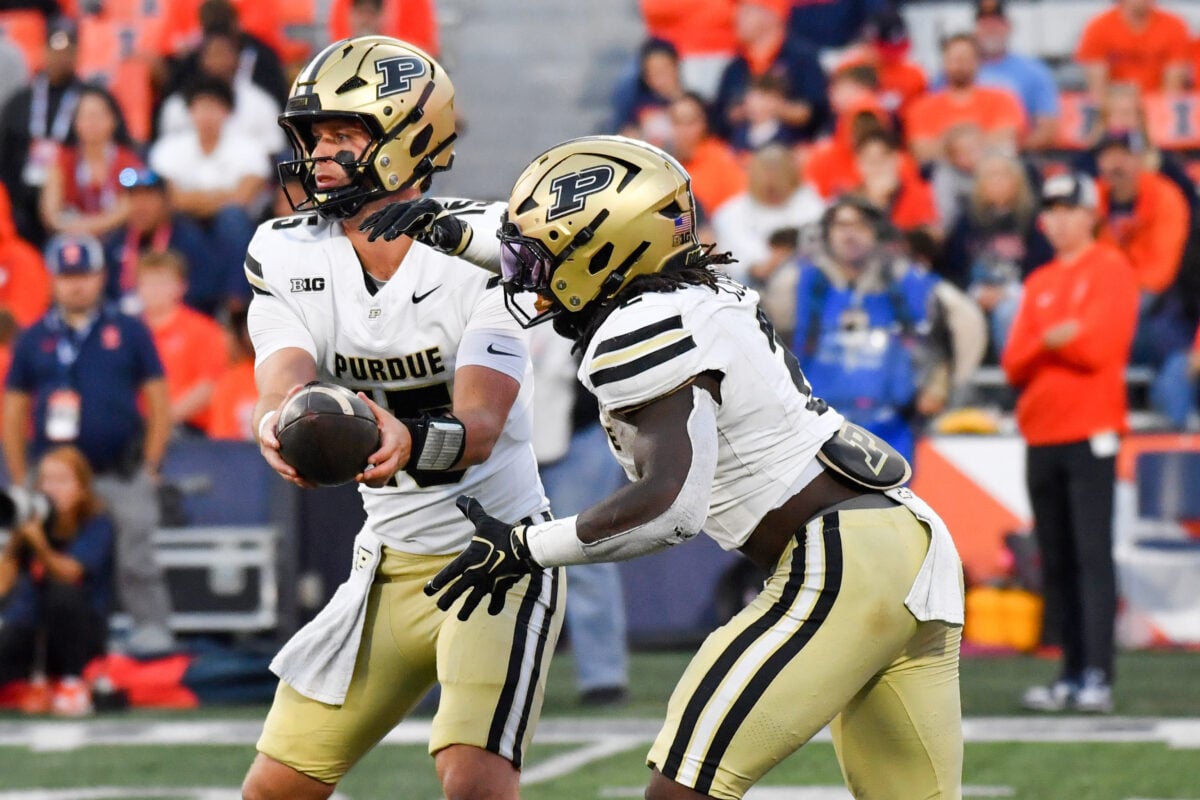 Oct 3, 2026; Champaign, Illinois, USA;  Purdue Boilermakers quarterback Ryan Browne (15) hands the ball to running back Fame Ijeboi (2) during the second half at Gies Memorial Stadium.  Mandatory Credit: Ron Johnson-Imagn Images