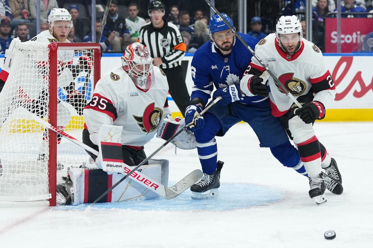 Oct 3, 2026; Toronto, Ontario, CAN; Toronto Maples Leafs ring wing Kirill Marchenko (86) battles for the puck with Ottawa Senators right wing Michael Amadio (22) during the third period at Scotiabank Arena. Mandatory Credit: Nick Turchiaro-Imagn Images
