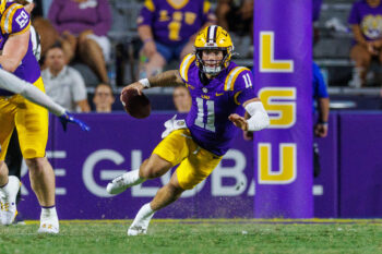 Oct 3, 2026; Baton Rouge, Louisiana, USA;  LSU Tigers quarterback Landen Clark (11) scrambles against the McNeese Cowboys during the second half at Tiger Stadium.  Mandatory Credit: Stephen Lew-Imagn Images