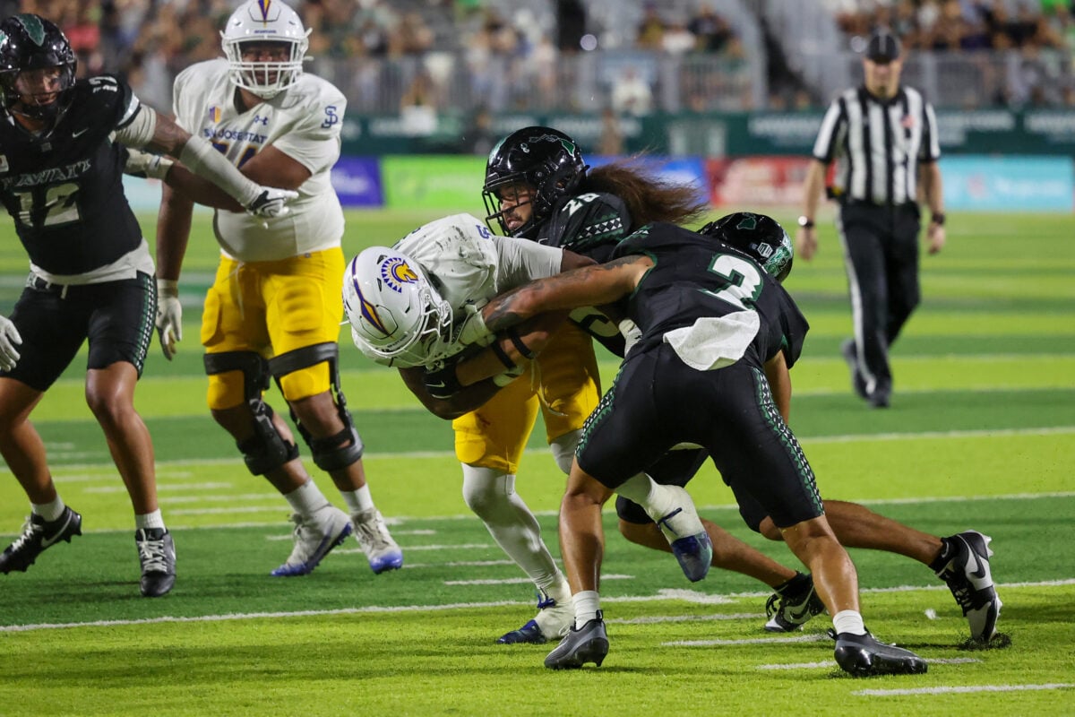 Oct 3, 2026; Honolulu, Hawaii, USA;  Hawaii Rainbow Warriors defensive back Matagi Thompson (25) and defensive back Kona Moore (2) go after San Jose State Spartans running back Jabari Bates during the fourth quarter at the Clarence T.C. Ching Athletics Complex.  Mandatory Credit: Marco Garcia-Imagn Images