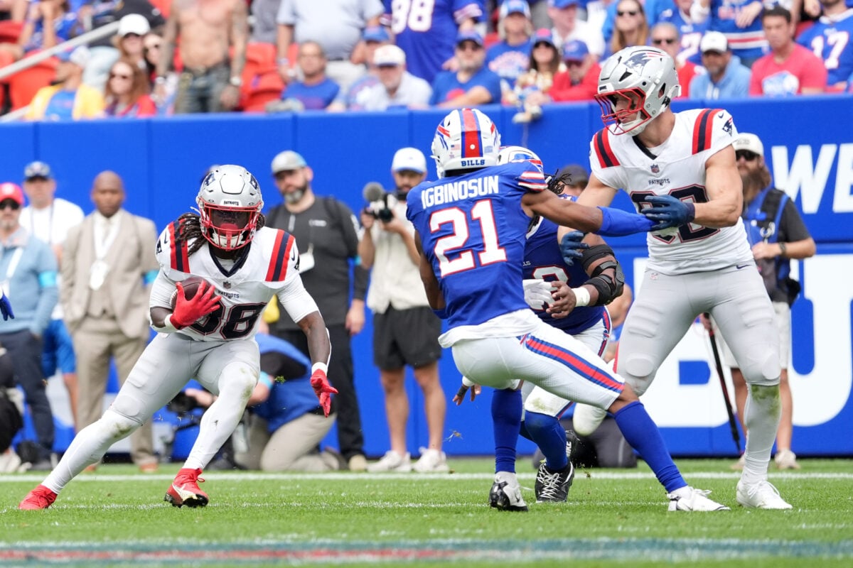 Oct 4, 2026; Orchard Park, New York, USA;  New England Patriots running back Rhamondre Stevenson (38) rushes as Buffalo Bills cornerback Davison Igbinosun (21) defends during the third quarter at New Highmark Stadium.  Mandatory Credit: Gregory Fisher-Imagn Images