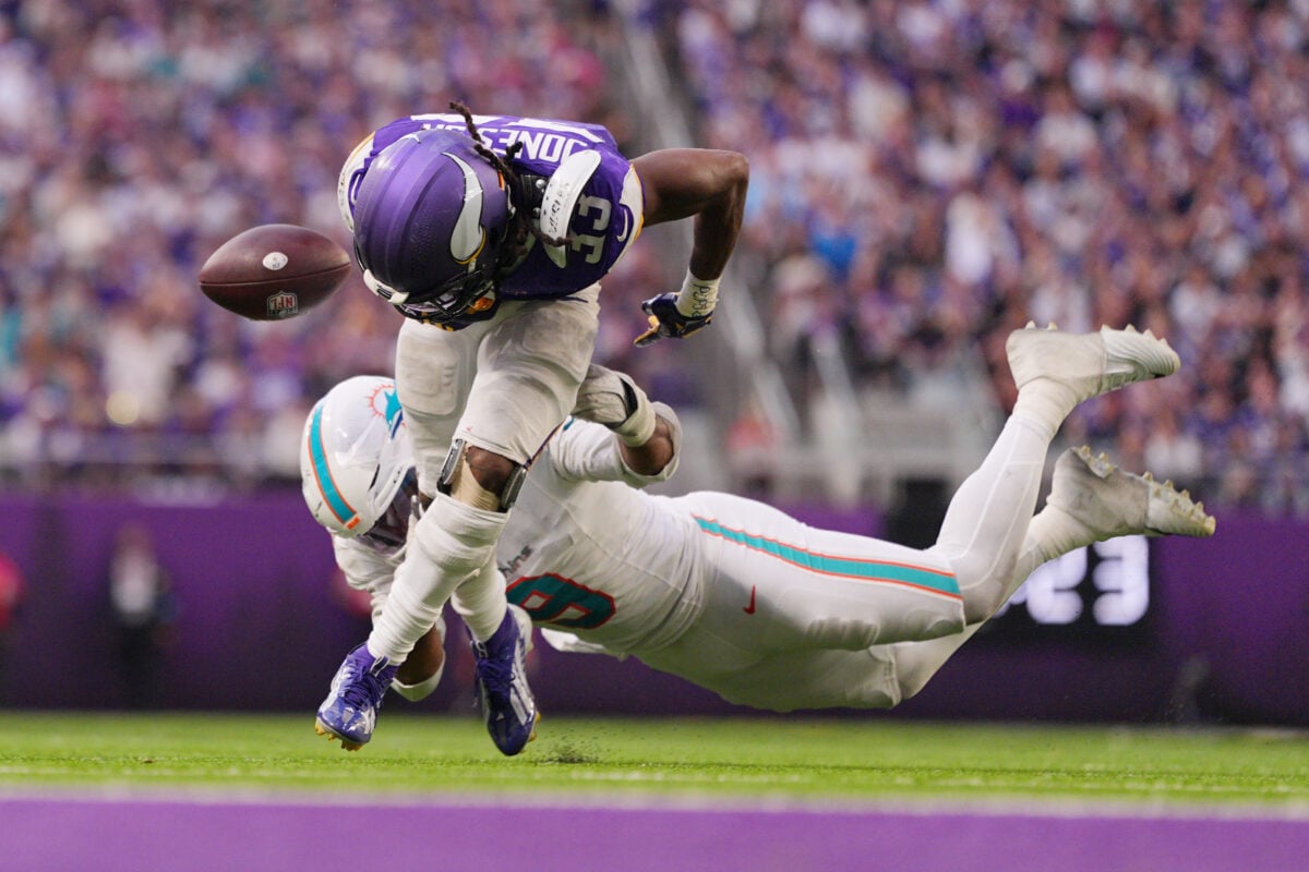 Oct 4, 2026; Minneapolis, Minnesota, USA; Miami Dolphins linebacker Joshua Uche (9) forces a fumble from Minnesota Vikings running back Aaron Jones (33) during the fourth quarter at U.S. Bank Stadium. Mandatory Credit: Brad Rempel-Imagn Images