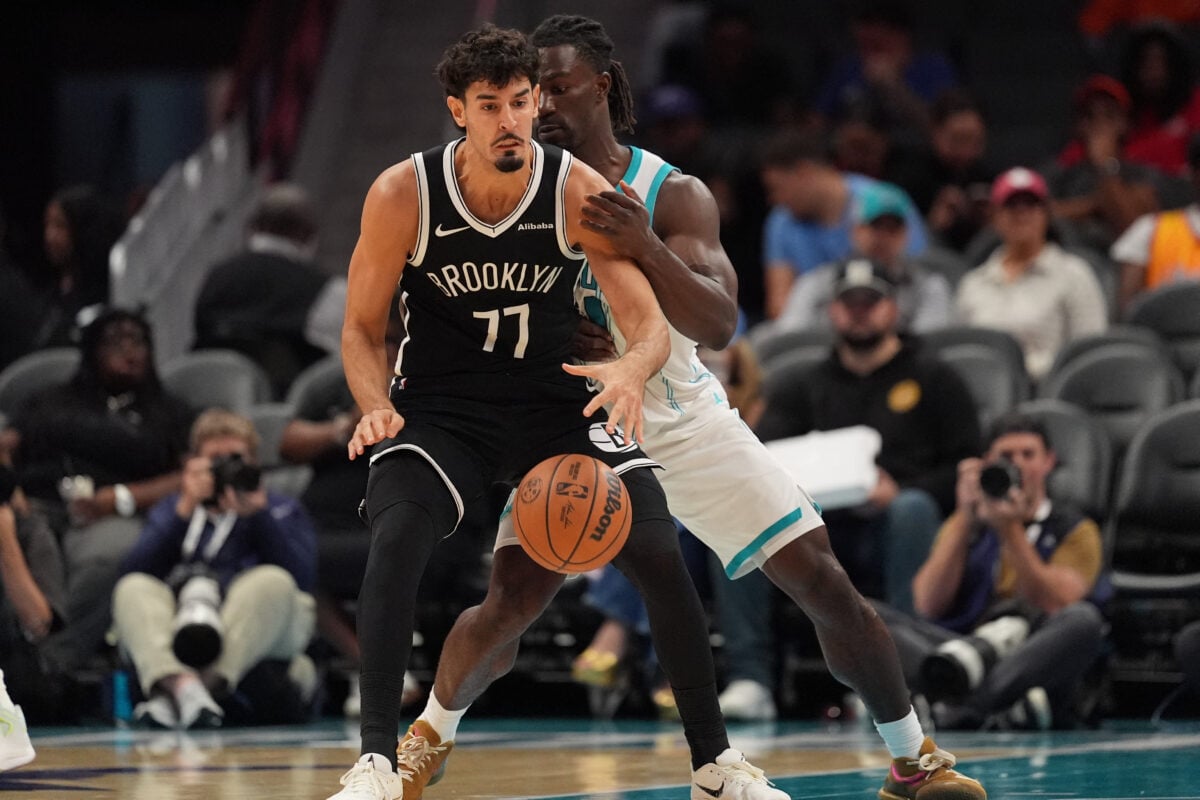 Oct 6, 2026; Charlotte, North Carolina, USA;  Charlotte Hornets guard Sion James (4) pressures Brooklyn Nets guard Ben Saraf (77) during the second half at Spectrum Center.  Mandatory Credit: Jim Dedmon-Imagn Images