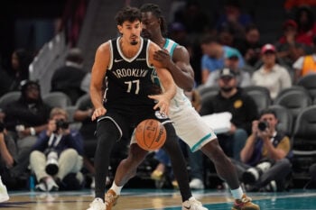 Oct 6, 2026; Charlotte, North Carolina, USA;  Charlotte Hornets guard Sion James (4) pressures Brooklyn Nets guard Ben Saraf (77) during the second half at Spectrum Center.  Mandatory Credit: Jim Dedmon-Imagn Images