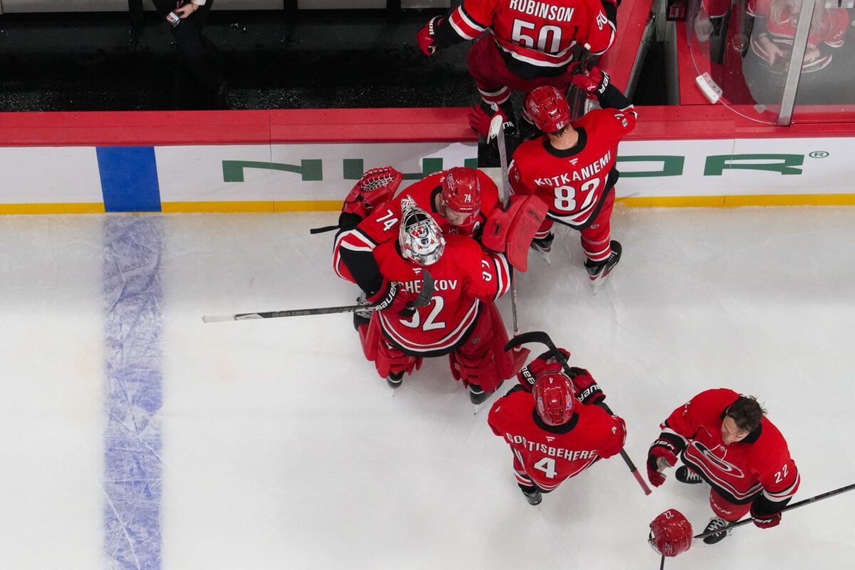 Oct 8, 2026; Raleigh, North Carolina, USA;  Carolina Hurricanes defenseman Jaccob Slavin (74) hugs goaltender Pyotr Kochetkov (52) after their victory against the Vancouver Canucks at Lenovo Center.  Mandatory Credit: James Guillory-Imagn Images