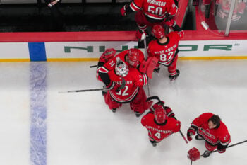 Oct 8, 2026; Raleigh, North Carolina, USA;  Carolina Hurricanes defenseman Jaccob Slavin (74) hugs goaltender Pyotr Kochetkov (52) after their victory against the Vancouver Canucks at Lenovo Center.  Mandatory Credit: James Guillory-Imagn Images