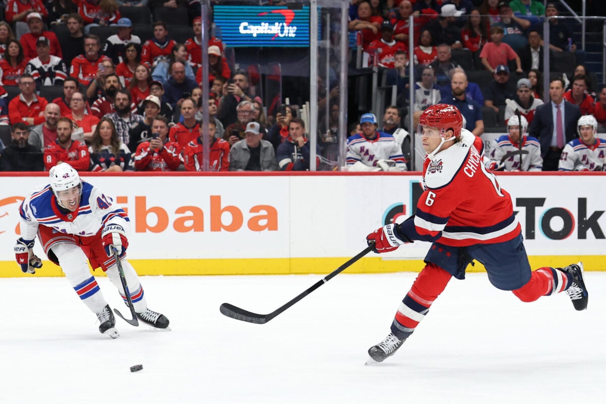Oct 9, 2026; Washington, District of Columbia, USA; Washington Capitals defenseman Jakob Chychrun (6) shoots the puck as New York Rangers center Noah Laba (42) defends during the first period at Capital One Arena. Mandatory Credit: Geoff Burke-Imagn Images