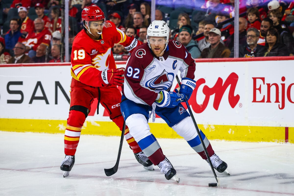 Oct 8, 2026; Calgary, Alberta, CAN; Colorado Avalanche left wing Gabriel Landeskog (92) and Calgary Flames defenseman Zayne Parekh (19) battle for the puck during the second period at Scotiabank Saddledome. Mandatory Credit: Sergei Belski-Imagn Images