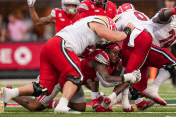 Ohio State Buckeyes defensive end Eddrick Houston (96) loses his helmet as he tackles Maryland Terrapins running back DeJuan Williams (0) during the NCAA football game at Ohio Stadium in Columbus on Oct. 10, 2026.