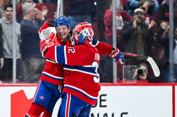 Oct 10, 2026; Montreal, Quebec, CAN;  Montreal Canadiens right wing Cole Caufield (13) jumps on goalie Jacob Fowler (32) to celebrate the win against the Detroit Red Wings at Bell Centre.  Mandatory Credit: David Kirouac-Imagn Images
