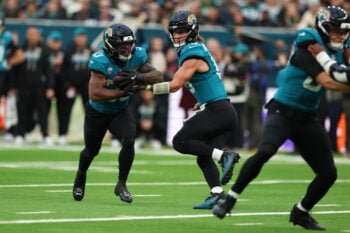 Oct 11, 2026; Tottenham, ENG;  Jacksonville Jaguars quarterback Trevor Lawrence (16) hands off to running back Bhayshul Tuten (33) during the second half against the Philadelphia Eagles at Tottenham Hotspur Stadium.  Mandatory Credit: Nathan Ray Seebeck-Imagn Images