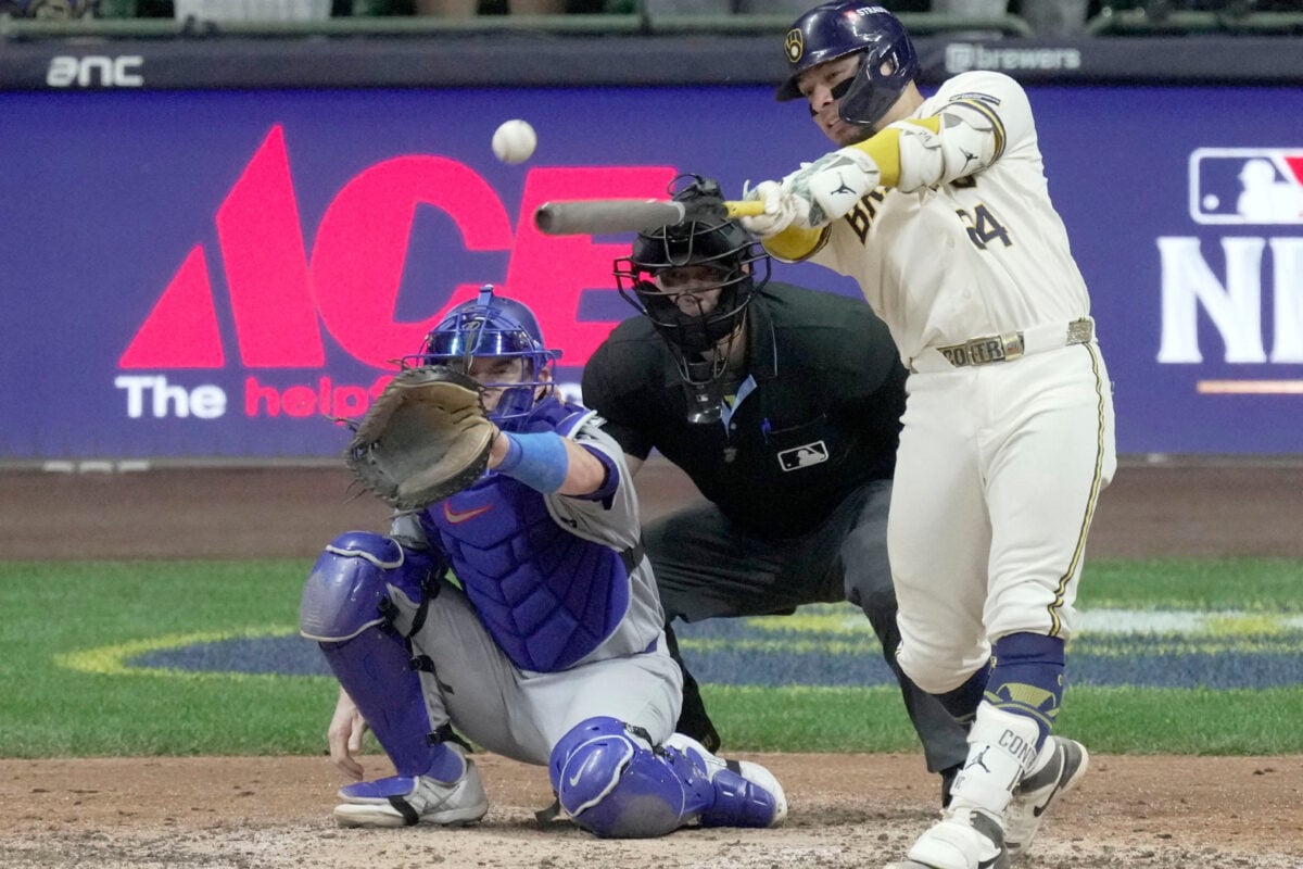 Oct 12, 2026; Milwaukee, Wisconsin, USA; Milwaukee Brewers catcher William Contreras (24) hits an RBI single during the sixth inning of their National League Championship Series game against the Los Angeles Dodgers at American Family Field on Oct 12, 2026.Mandatory Credit: Mark Hoffman-USA TODAY Network via Imagn Images