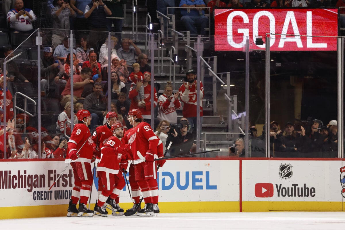 Oct 13, 2026; Detroit, Michigan, USA;  Detroit Red Wings right wing Alex DeBrincat (93) receives congratulations from teammates after scoring in the third period against the New Jersey Devils at Little Caesars Arena.  Mandatory Credit: Rick Osentoski-Imagn Images