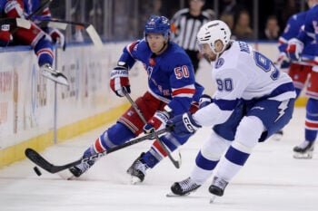 Oct 13, 2026; New York, New York, USA; Tampa Bay Lightning defenseman J.J. Moser (90) fights for the puck against New York Rangers left wing Will Cuylle (50) during the third period at Madison Square Garden. Mandatory Credit: Brad Penner-Imagn Images