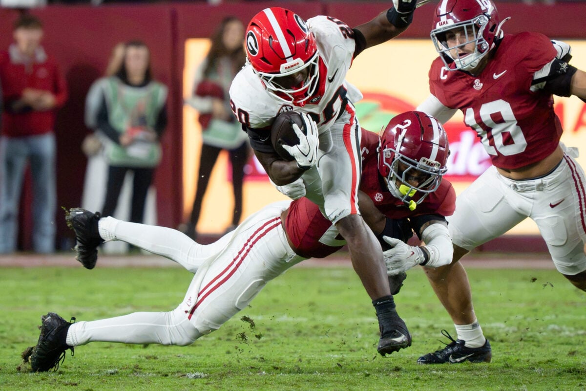 Georgia running back Dwight Phillips Jr. tries to avoid the tackle attempt of Alabama defensive back Zabien Brown (2) at Saban Field at Bryant-Denny Stadium.