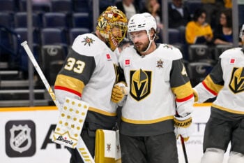 Oct 13, 2026; Nashville, Tennessee, USA;  Vegas Golden Knights defenseman Rasmus Andersson (4) celebrates the win with goaltender Adin Hill (33) against the Nashville Predators during the third period at Bridgestone Arena. Mandatory Credit: Steve Roberts-Imagn Images