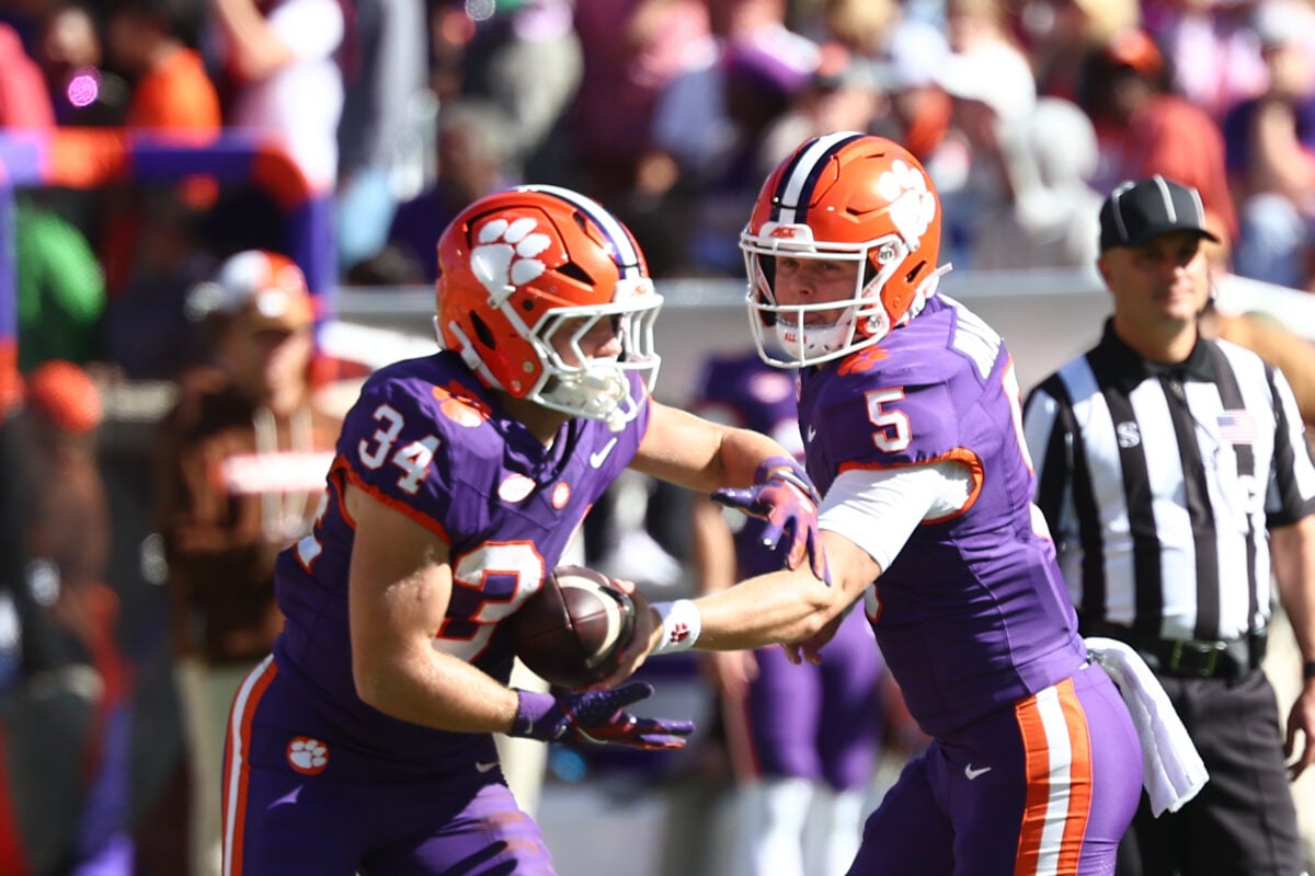 Oct 17, 2026; Clemson, South Carolina, USA;  Clemson Tigers quarterback Brock Bradley (5) hands the ball off to  running back Max Wilson (34) during the fourth quarter against Charleston Southern Buccaneers at Memorial Stadium.  Mandatory Credit: Ashley Tumlin-Imagn Images