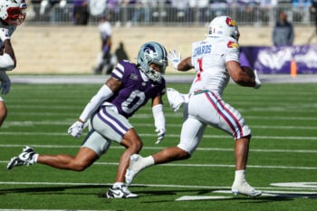 Oct 17, 2026; Manhattan, Kansas, USA;  Kansas State Wildcats safety Koy Beasley (0) tries to tackle Kansas Jayhawks running back Dylan Edwards (1) during the fourth quarter at Bill Snyder Family Football Stadium.  Mandatory Credit: Scott Sewell-Imagn Images