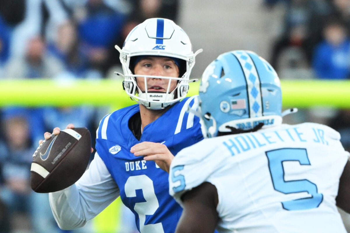 Oct 17, 2026; Durham, North Carolina, USA;  Duke Blue Devils quarter back Walker Eget (2) looks for a pass against North Carolina Tar Heels defensive lineman Donovan Hoilette Jr. (5) during the third quarter at Wallace Wade Stadium.  Mandatory Credit: Zachary Taft-Imagn Images