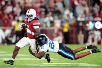 Oklahoma's Tory Blaylock (6) tries to get by Kentucky's Grant Godfrey (22) in the first half of the college football game between the University of Oklahoma Sooners (OU) and the Kentucky Wildcats at Gaylord Family — Oklahoma Memorial Stadium in Norman, Okla.,  Saturday, Oct., 17, 2026.