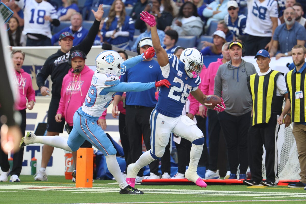 Oct 18, 2026; Indianapolis, Indiana, USA; Indianapolis Colts running back Jonathan Taylor (28) runs with the ball against Tennessee Titans safety Tony Adams (29) during the second half at Lucas Oil Stadium. Mandatory Credit: Trevor Ruszkowski-Imagn Images