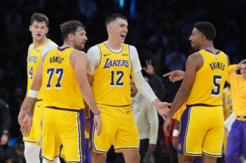 Oct 21, 2026; Los Angeles, California, USA; Los Angeles Lakers guard Luka Doncic (77), forward Jake LaRavia (12) and guard Quentin Grimes (5) react against the Golden State Warriorsin the first half at Crypto.com Arena. Mandatory Credit: Kirby Lee-Imagn Images