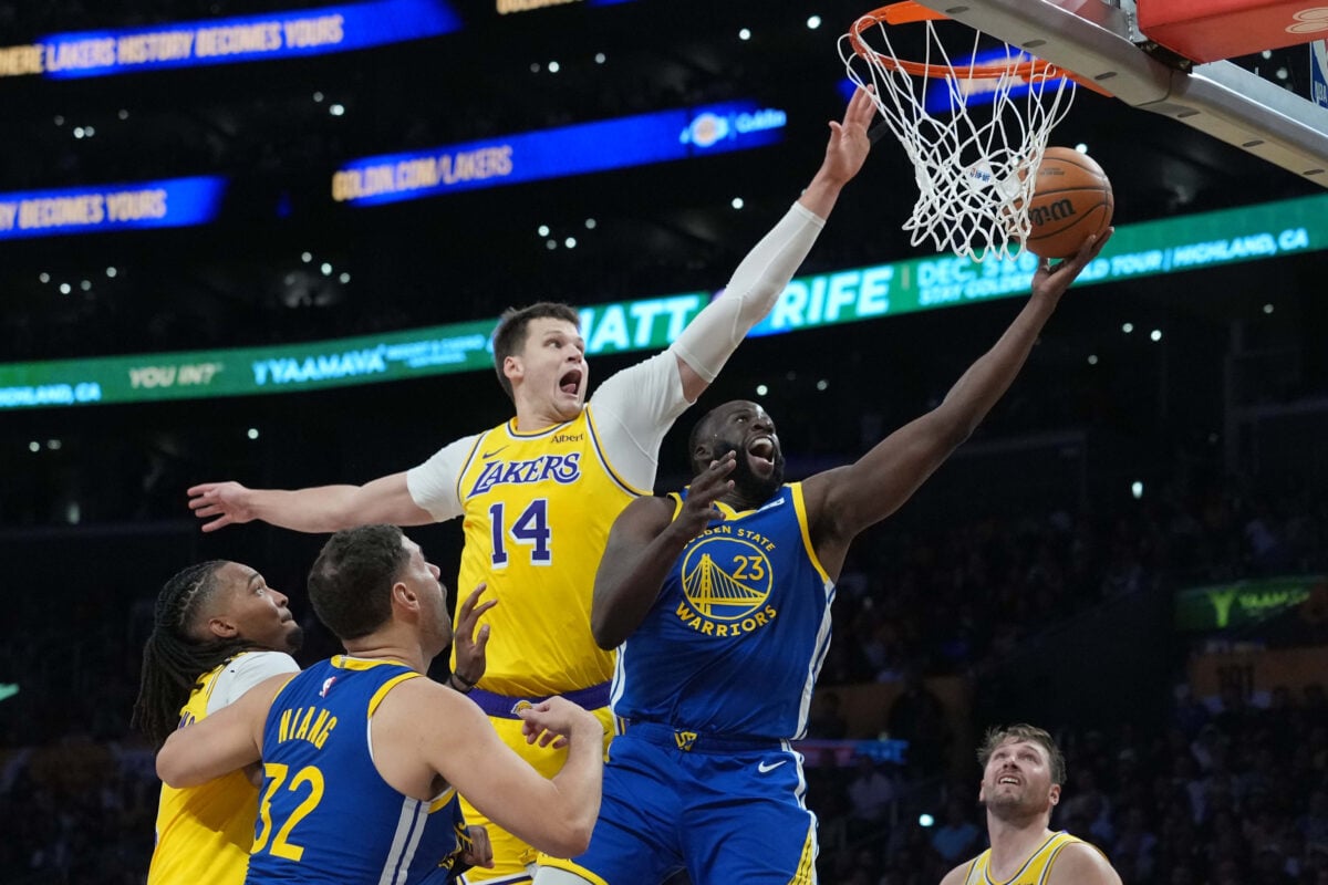 Oct 21, 2026; Los Angeles, California, USA; Golden State Warriors forward Draymond Green (23) shoots the ball against Los Angeles Lakers center Walker Kessler (14) in the second half at the Crypto.com Arena. Mandatory Credit: Kirby Lee-Imagn Images