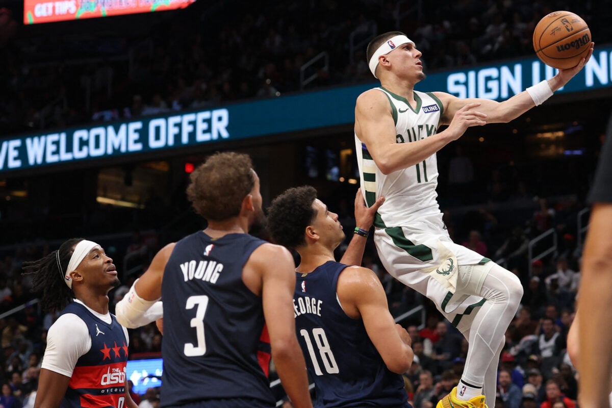 Oct 21, 2026; Washington, District of Columbia, USA; Milwaukee Bucks guard Tyler Herro (11) shoots the ball as Washington Wizards guard Bilal Coulibaly (0) and Wizards guard Trae Young (3) look on in the second half at Capital One Arena. Mandatory Credit: Geoff Burke-Imagn Images