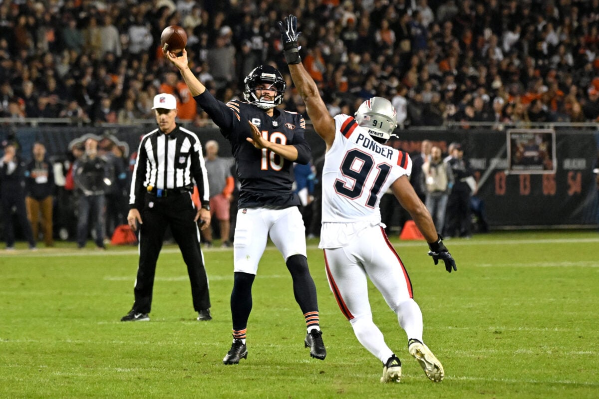 Oct 22, 2026; Chicago, Illinois, USA;  Chicago Bears quarterback Caleb Williams (18) throws agaisnt New England Patriots linebacker Elijah Ponder (91) during the first half at Soldier Field.  Mandatory Credit: Matt Marton-Imagn Images