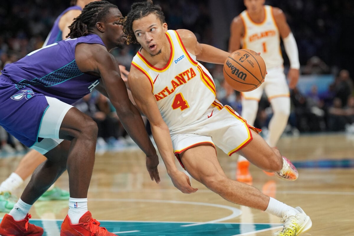 Oct 23, 2026; Charlotte, North Carolina, USA;  Atlanta Hawks guard Kingston Flemings (4) drives to the basket against Charlotte Hornets guard Sion James (4) during the first half at the Spectrum Center.  Mandatory Credit: Jim Dedmon-Imagn Images