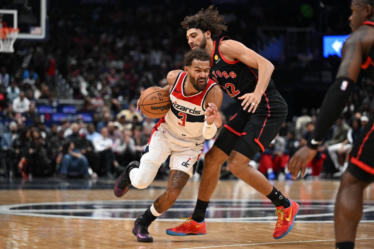 Oct 23, 2026; Washington, District of Columbia, USA; Washington Wizards guard Trae Young (3) drives as Toronto Raptors forward Allen Graves (22) defends during the first half at Capital One Arena. Mandatory Credit: Brad Mills-Imagn Images
