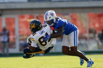 Oct 24, 2026; Dallas, Texas, USA;  California Golden Bears wide receiver Tyree Sams (81) is tackled by SMU Mustangs safety Sael Reyes (22) during the second half at Gerald J. Ford Stadium.  Mandatory Credit: Chris Jones-Imagn Images