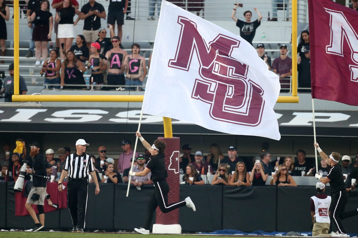 Oct 24, 2026; Starkville, Mississippi, USA;  Mississippi State Bulldogs cheerleaders runs a Mississippi State flag across the filed after a touchdown during the fourth quarter against the Oklahoma Sooners at Davis Wade Stadium at Scott Field.  Mandatory Credit: Petre Thomas-Imagn Images