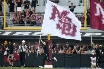 Oct 24, 2026; Starkville, Mississippi, USA;  Mississippi State Bulldogs cheerleaders runs a Mississippi State flag across the filed after a touchdown during the fourth quarter against the Oklahoma Sooners at Davis Wade Stadium at Scott Field.  Mandatory Credit: Petre Thomas-Imagn Images