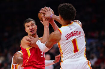 Oct 24, 2026; Atlanta, Georgia, USA;  Houston Rockets guard Bogdan Bogdanovic (31) looks to pass against Atlanta Hawks forward Jalen Johnson (1) in the fourth quarter at State Farm Arena.  Mandatory Credit: Colin Hubbard-Imagn Images