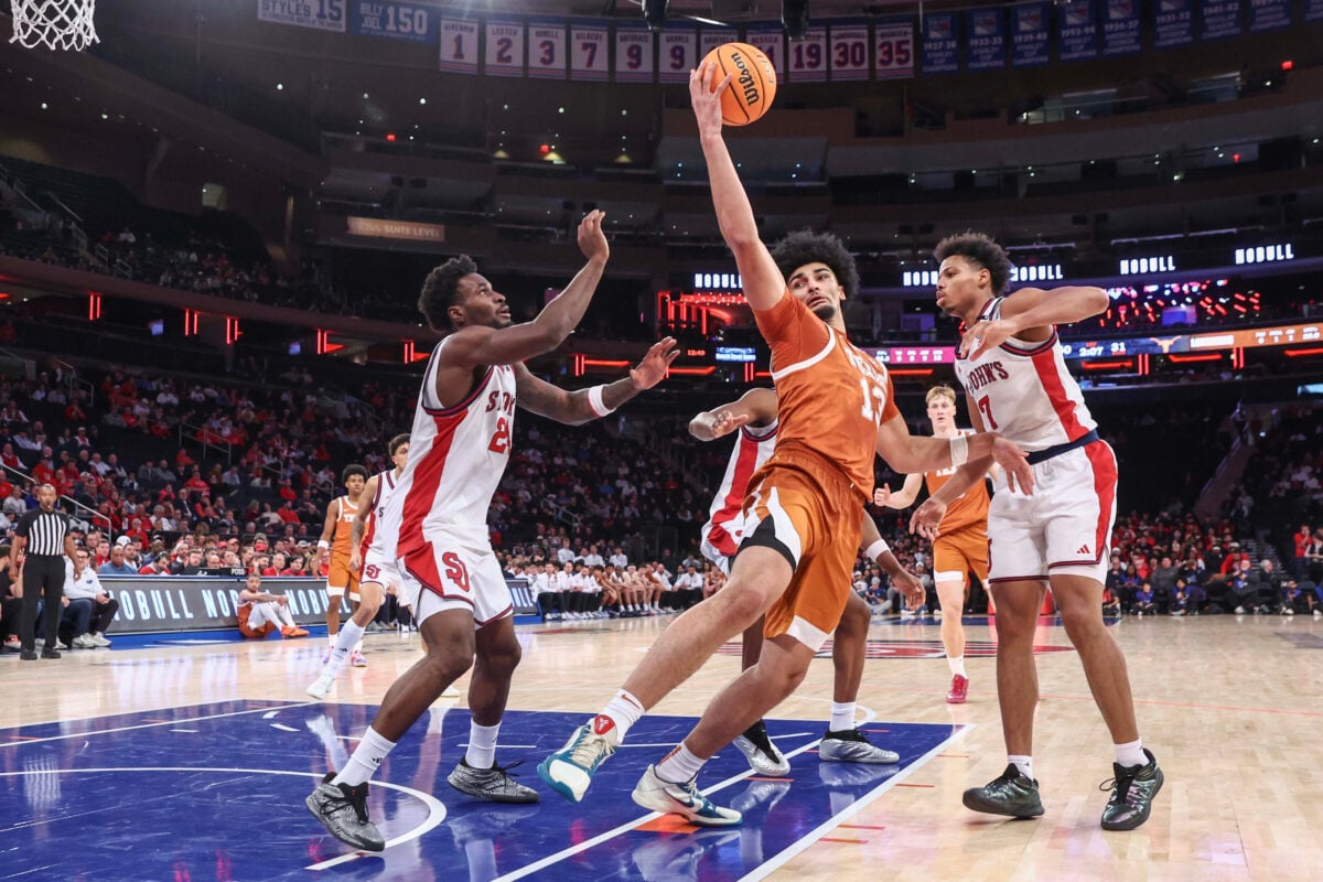 Oct 25, 2026; New York, NY, USA; Texas Longhorns forward David Punch (13) grabs a rebound in between St. John's Red Storm guard Tounde Yessoufou (24) and forward Keyshawn Hall (7) in the first half at Madison Square Garden. Mandatory Credit: Wendell Cruz-Imagn Images