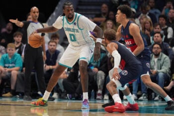 Oct 26, 2026; Charlotte, North Carolina, USA;  Charlotte Hornets center Naz Reid (0) works the ball against Washington Wizards forward Kyshawn George (18) and guard Trae Young (3) during the second half at the Spectrum Center.  Mandatory Credit: Jim Dedmon-Imagn Images
