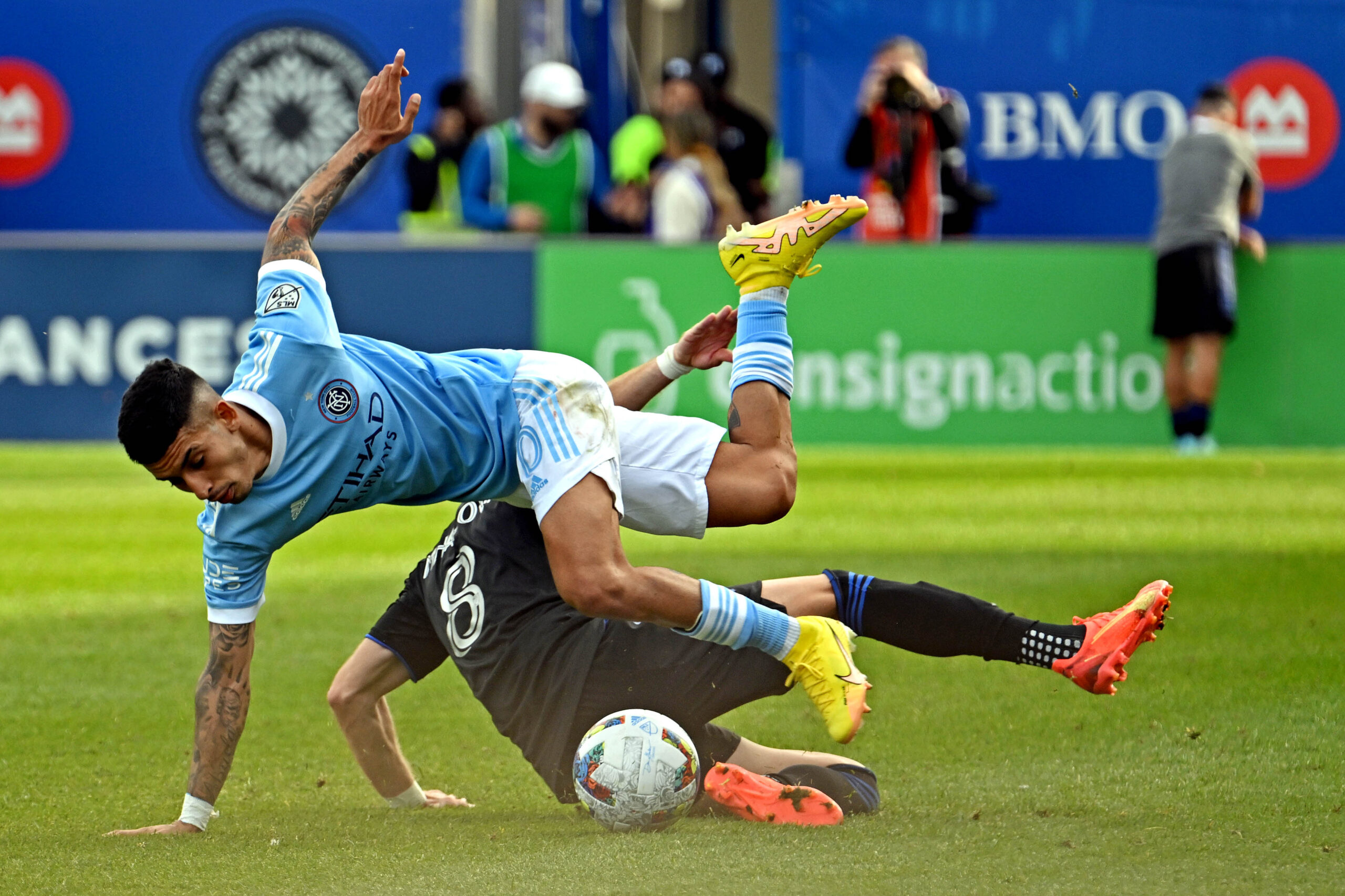 Oct 23, 2022; Montreal, Quebec, Canada; New York City midfielder Santiago Rodriguez (20) and CF Montreal midfielder Djordje Mihailovic (8) go for the ball during the second half during the conference semifinals for the Audi 2022 MLS Cup Playoffs at Stade Saputo. Mandatory Credit: David Kirouac-Imagn Images