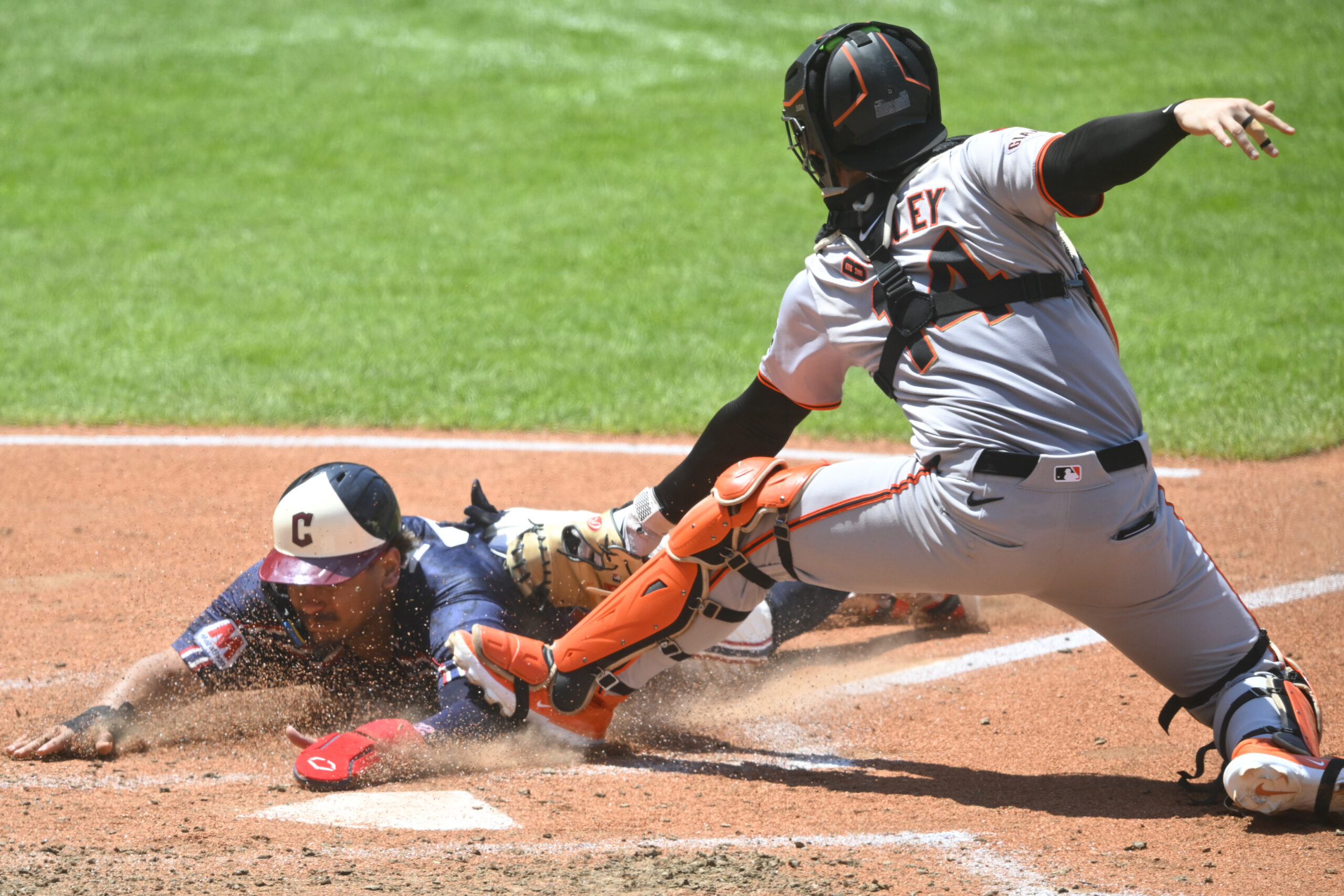 Jul 7, 2024; Cleveland, Ohio, USA; Cleveland Guardians first baseman Josh Naylor (22) is tagged out at home plate by San Francisco Giants catcher Patrick Bailey (14) in the fourth inning at Progressive Field. Mandatory Credit: David Richard-Imagn Images