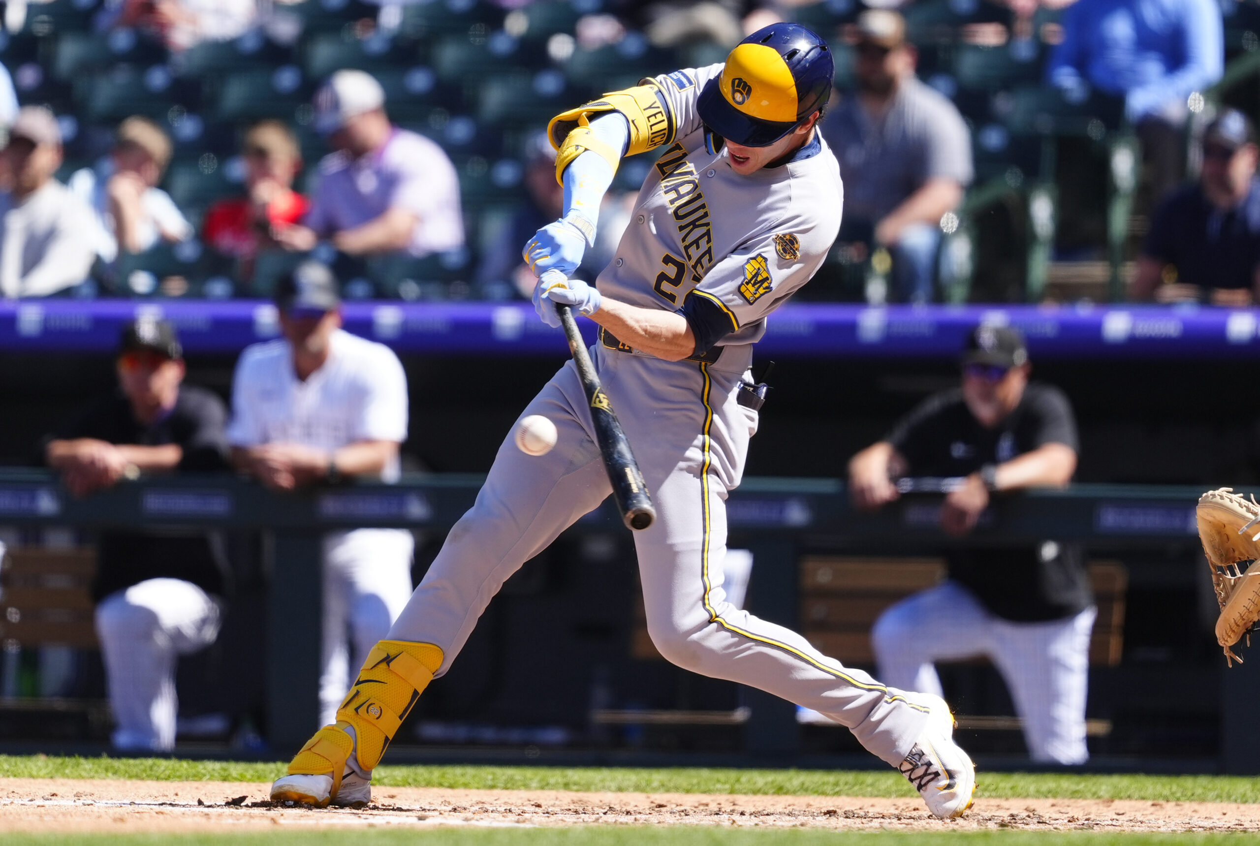 Apr 10, 2025; Denver, Colorado, USA; Milwaukee Brewers outfielder Christian Yelich (22) doubles in the fourth inning against the Colorado Rockies at Coors Field. Mandatory Credit: Ron Chenoy-Imagn Images